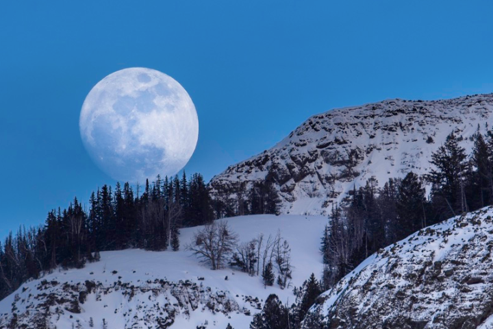 a man standing on top of a snow covered mountain